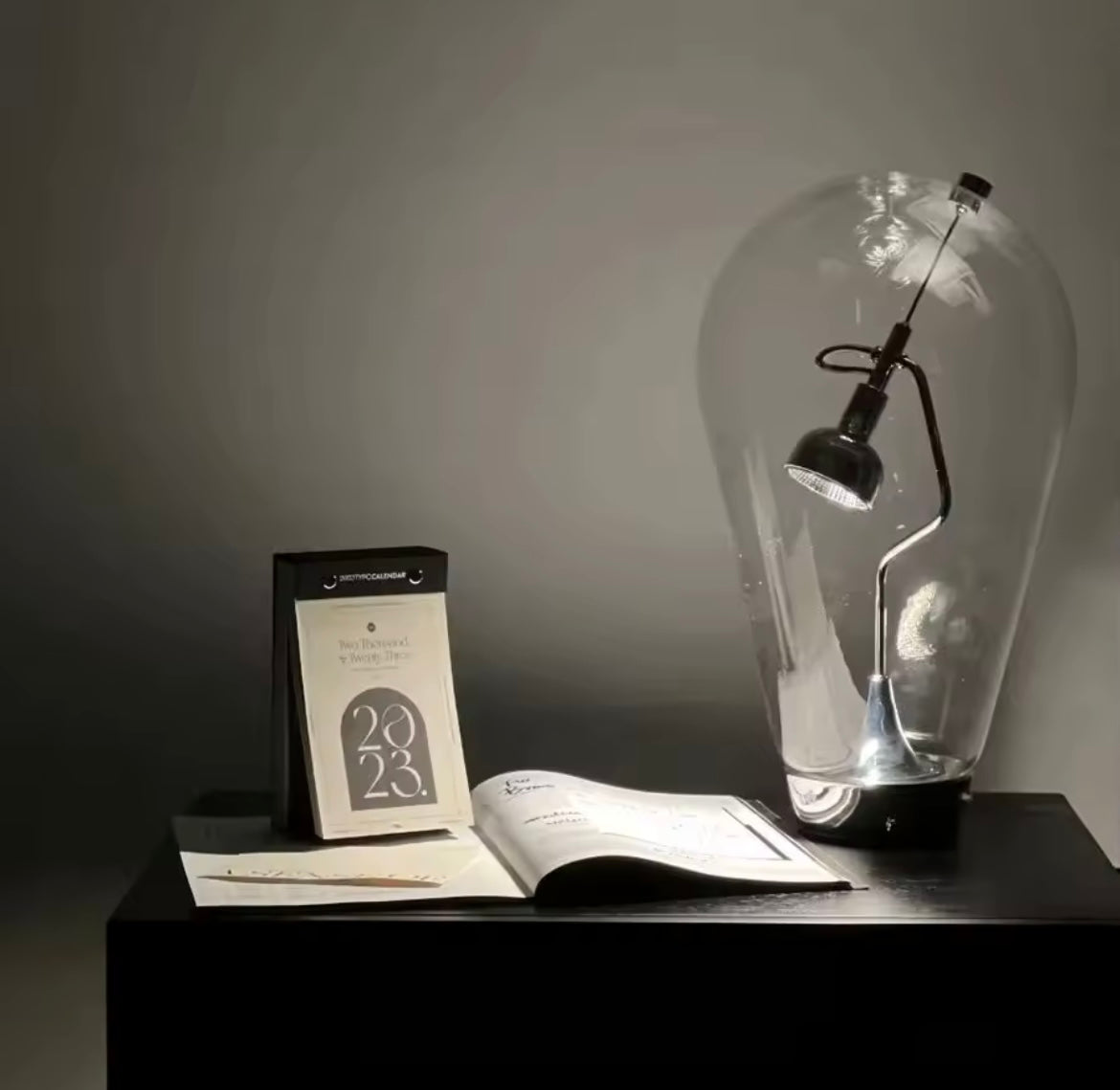 Italian minimalist glass desk lamp with magnetic touch control, retro-modern design for bedside or office lighting.
